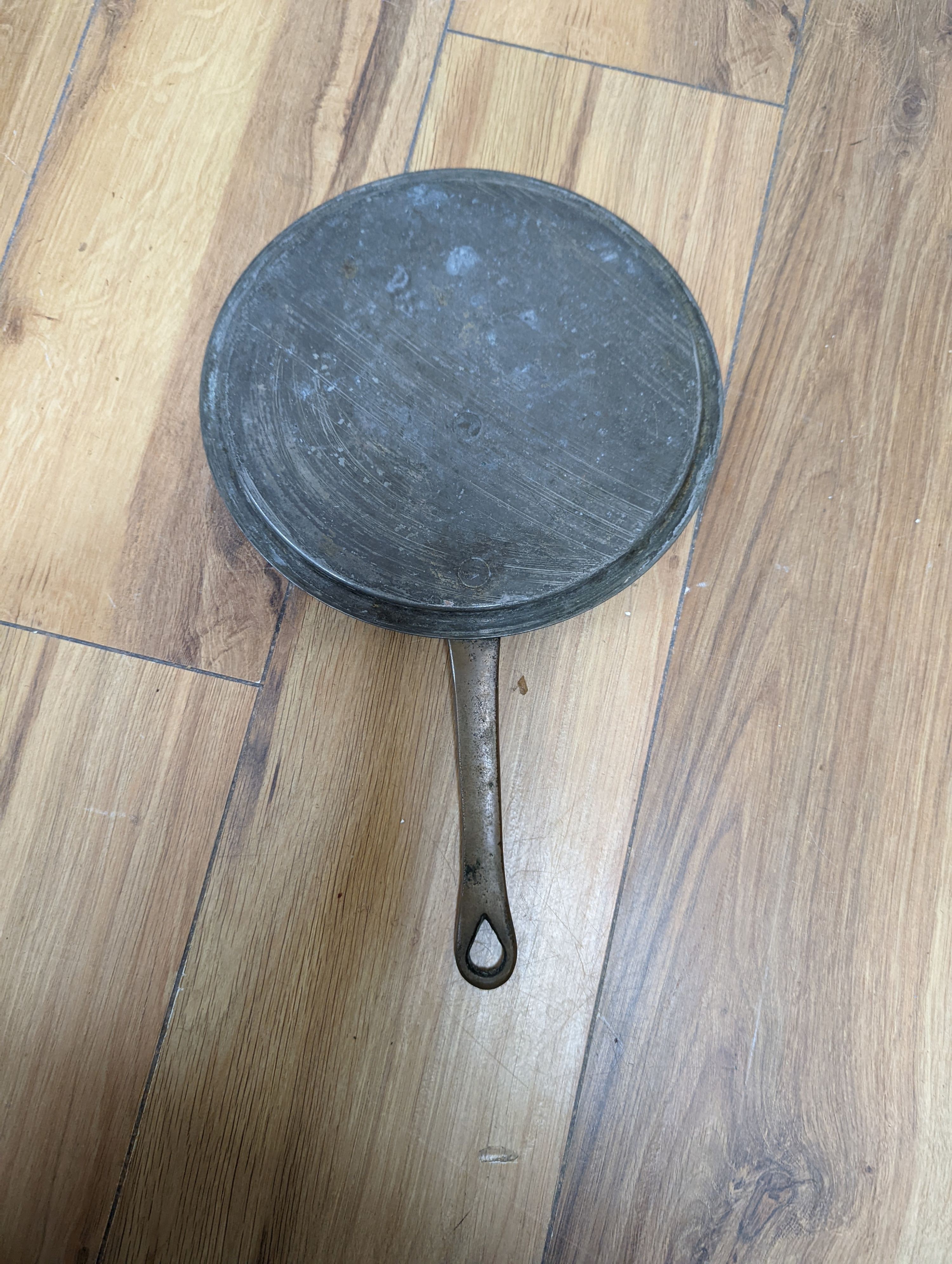 A group of three Jaeggi & Sons copper saucepans